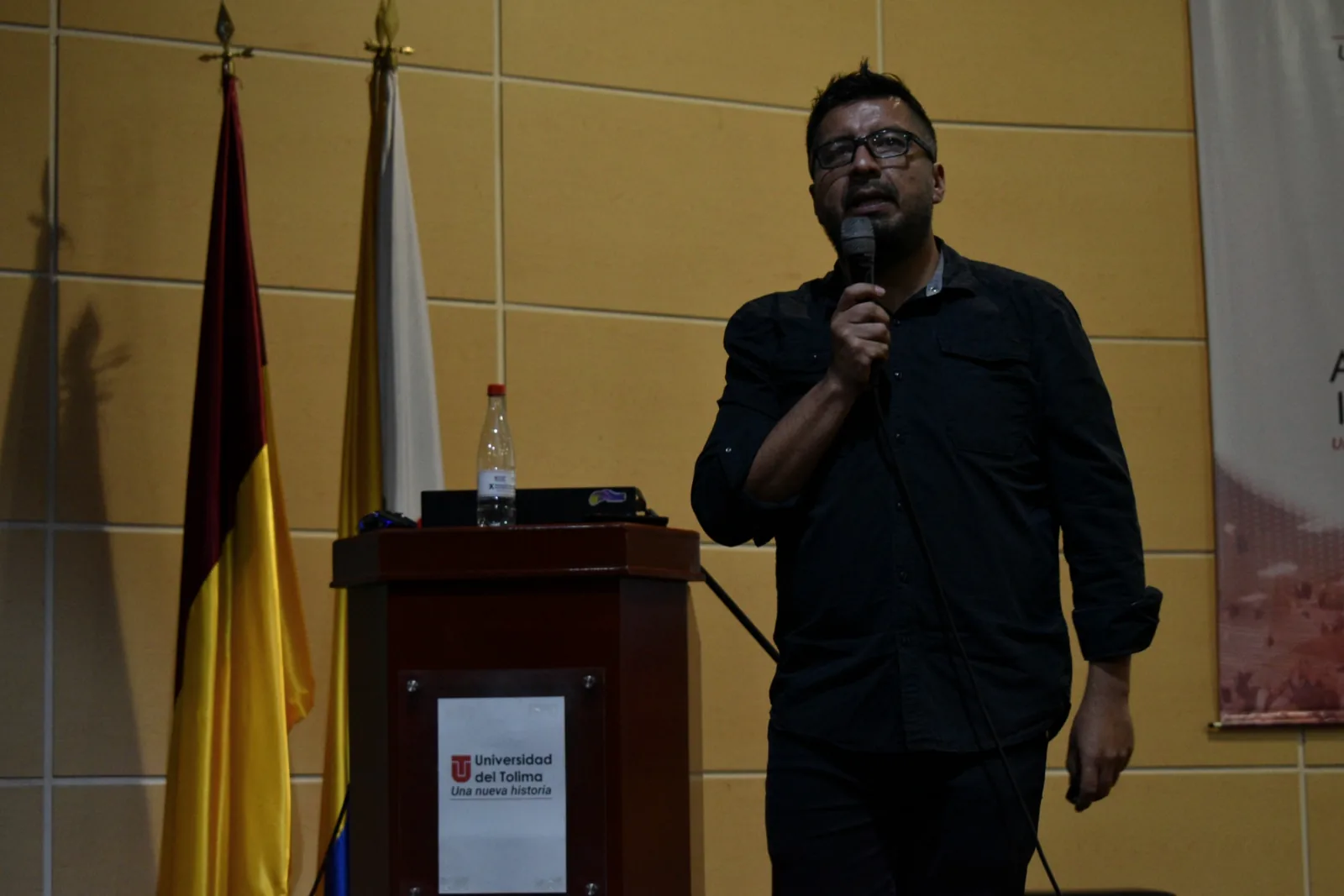Óscar Valbuena con micrófono durante una conferencia universitaria